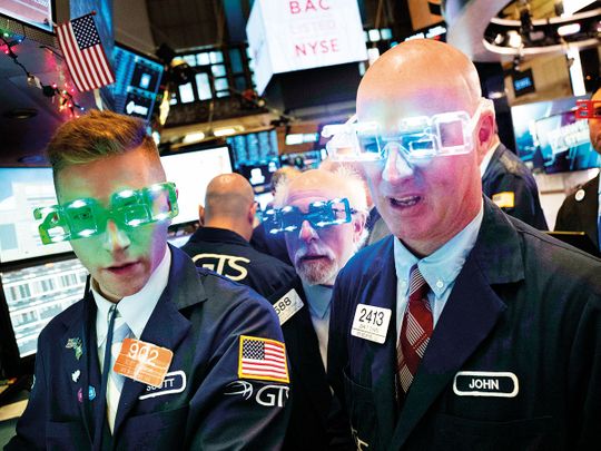 Traders wear New Year’s 2020 party glasses at the New York Stock Exchange
