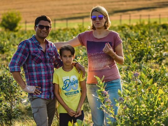 Ajay, Ramona and Oliver at their blueberry farm
