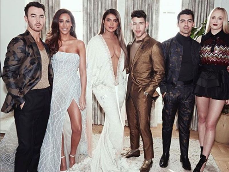 Jonas Brothers and their spouses.