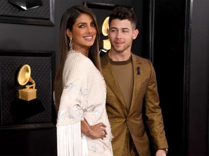 Priyanka Chopra (L) and US singer-songwriter Nick Jonas arrive for the 62nd Annual Grammy Awards in Los Angeles