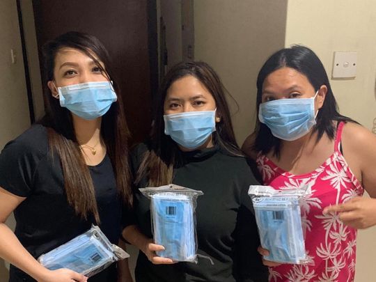 Happy recipients of free face masks in Dubai   