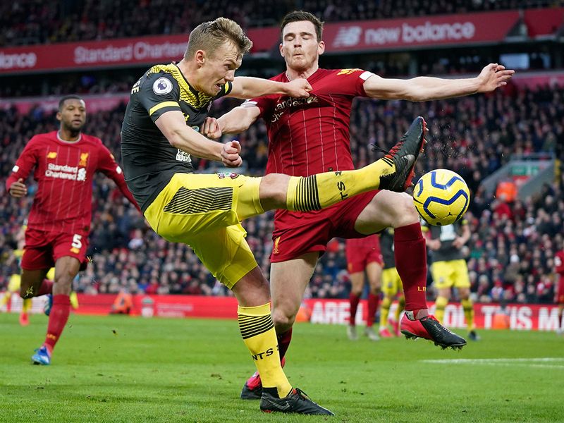 Liverpool's Andrew Robertson, right, challenges Southampton's James Ward-Prowse 