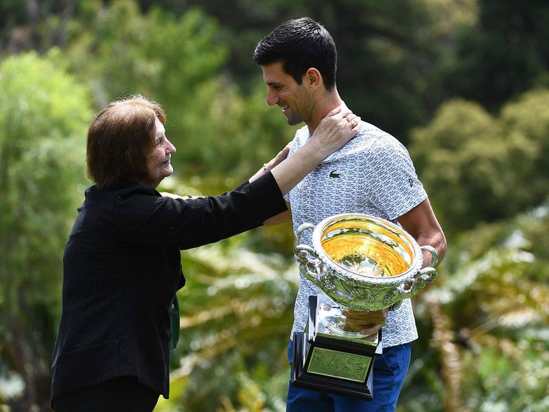 A fan gives Serbia's Novak Djokovic a hug