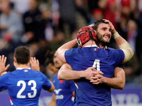 France's Charles Ollivon celebrates avith Bernard Leroux after defeating England during the Six Nations rugby union international match between France and England at the Stade de France in Paris