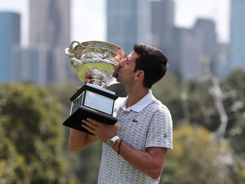 Serbia's Novak Djokovic with the Australian Open at Melbourne's Royal Botanic Gardens following his win over Austria's Dominic Thiem