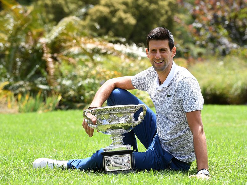Serbia's Novak Djokovic with the Australian Open at Melbourne's Royal Botanic Gardens following his win over Austria's Dominic Thiem