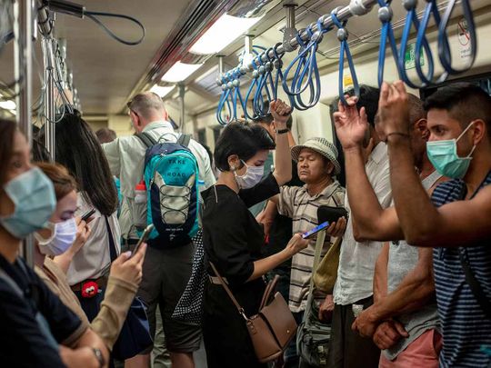 Commuters wear face masks