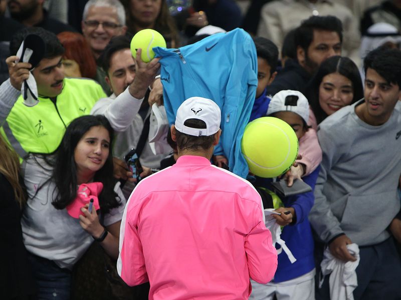 Rafael Nadal of Spain signs autographs for fans after an exhibition game to inaugurate the Rafa Nadal Academy Kuwait, at Shaikh Jaber Al Abdullah Al Jaber Al Sabah International Tennis Complex in the Kuwaiti capital, on February 5, 2020.  / AFP / Yasser Al-Zayyat