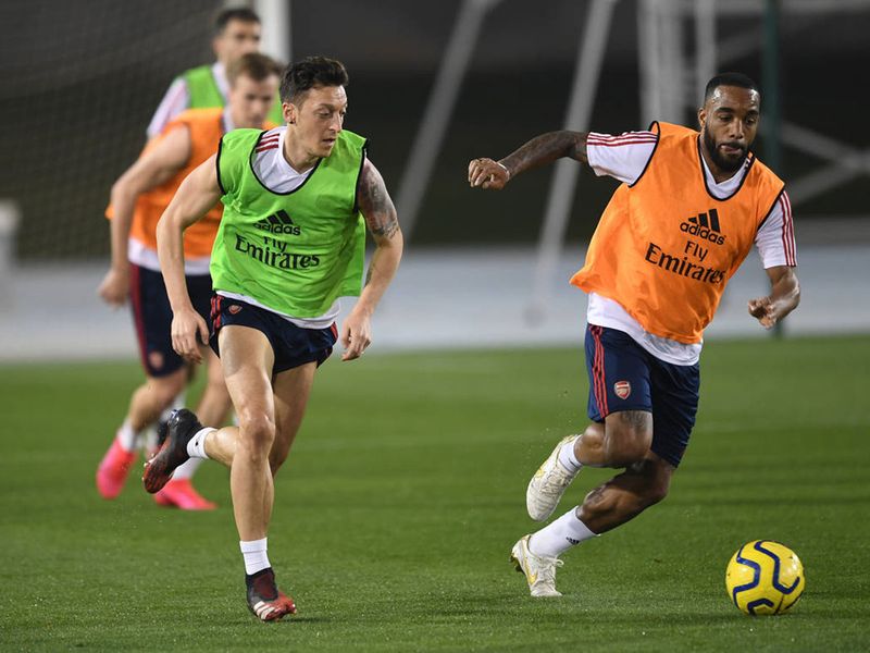 Ozil, pictured with Alexandre Lacazette, will be keen to impress Arteta, having seen a dip in form recently