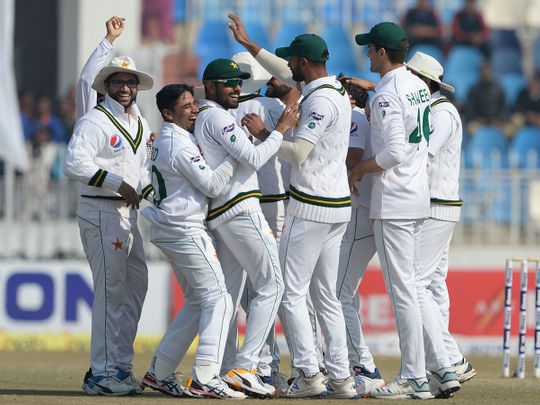 Pakistan's cricketers celebrate after the dismissal of Bangladesh's Rubel Hossain during the fourth day of the first Test in Rawalpindi