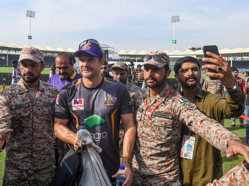 Rangers escort Quetta Gladiators' Shane Watson of Australia as he leaves the ground after a practice session for the upcoming 2020 Pakistan Super League (PSL) at National Stadium in Karachi