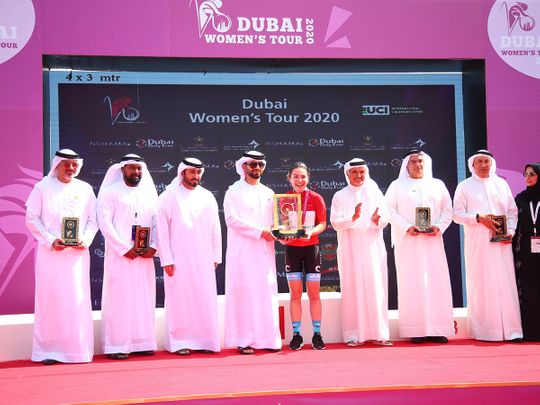 Sheikh Mansoor bin Mohammed Al Maktoum, Chairman of the Dubai Sports Council, presents Lucy Van Der Haar with the Dubai Women's Tour trophy