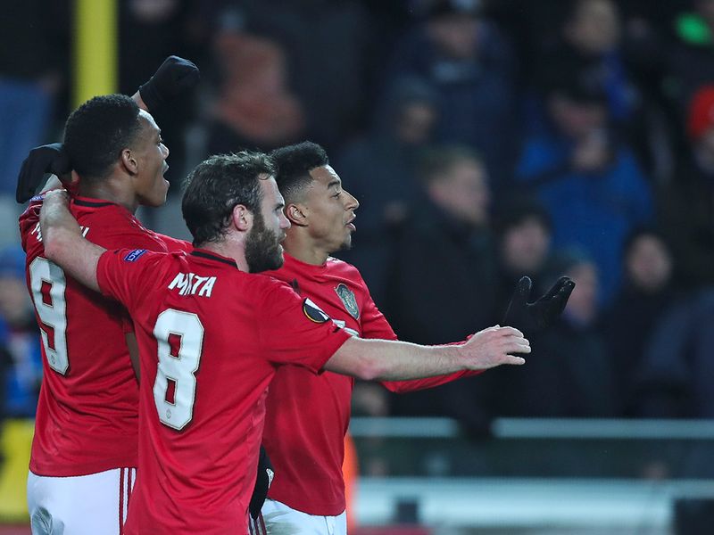 Manchester United's Anthony Martial, left, celebrates with teammates after scoring his side's first goal during an Europa League round of 32 first leg soccer match between Brugge and Manchester United 
