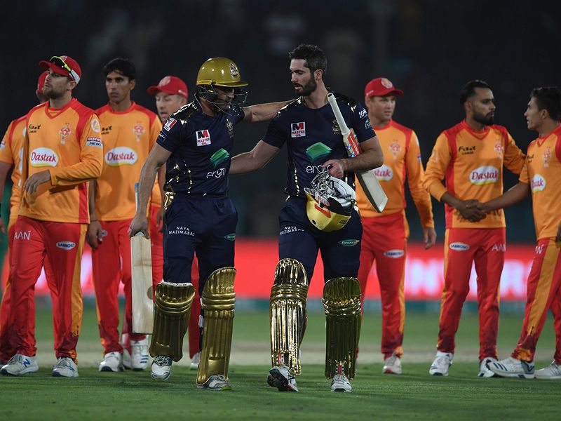 Quetta Gladiators' Ben Cutting (front R) and Abdul Nasir (front L) walk back the pavilion after winning the Pakistan Super League (PSL) Twenty20 cricket match between Quetta Gladiators and Islamabad United at The National Cricket Stadium in Karachi on February 20, 2020.  / AFP / Asif HASSAN