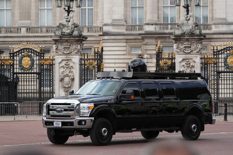 Security personnel surround the official vehicle of Indian Prime