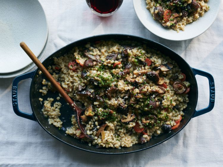 Baked barley risotto with mushrooms and carrots.-1582461899855