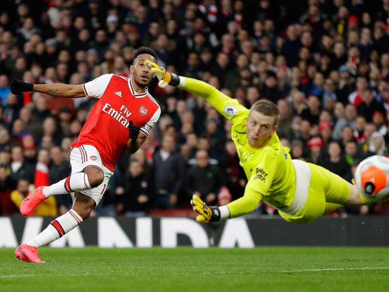 Arsenal's Pierre-Emerick Aubameyang scores his side's second goal as Everton's goalkeeper Jordan Pickford fails to save the ball during the English Premier League soccer match between Arsenal and Everton at Emirates stadium in London, Sunday, Feb. 23, 2020. (AP Photo/Kirsty Wigglesworth)