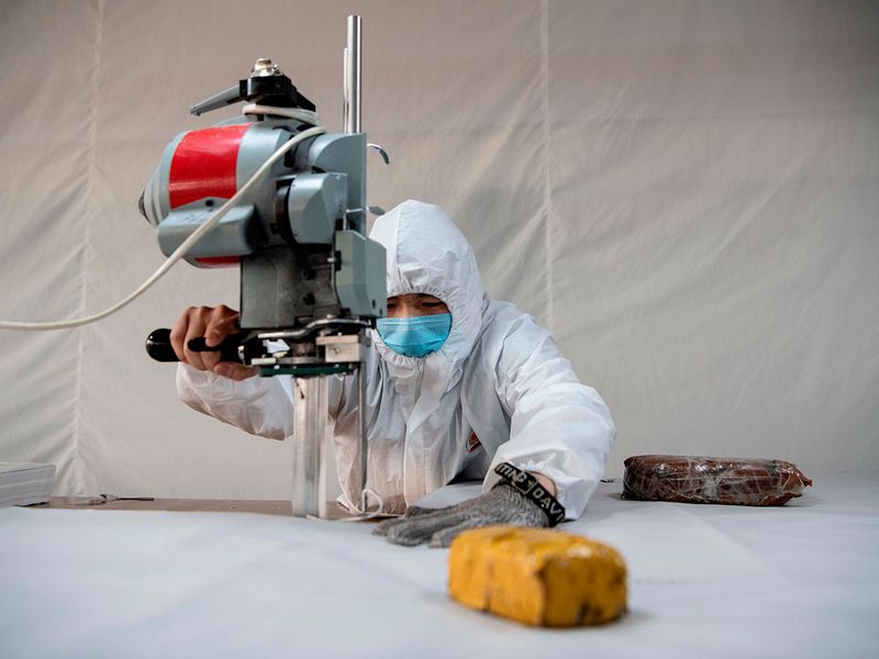 In virus-hit China, coat maker adapts to make hazmat suits
