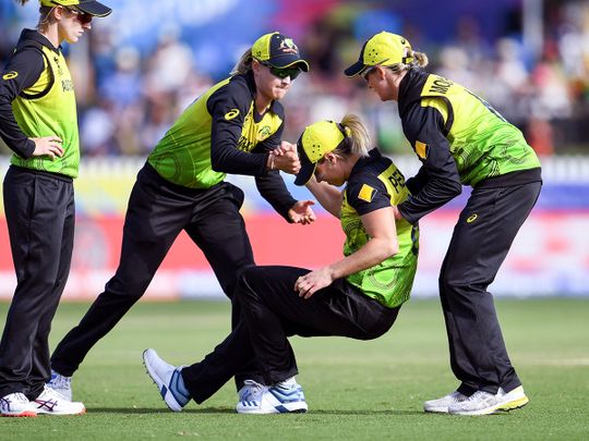 Australia's Ellyse Perry (2nd R) is helped to her feet by teammates after being injured in their Twenty20 women's World Cup cricket match against New Zealand in Melbourne 