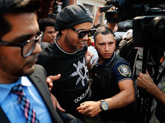 Former Brazilian soccer star Ronaldinho, whose full name is Ronaldo de Assis Moreira, center, leaves the attorney general office in Asuncion, Paraguay, Thursday, March 5, 2020. Ronaldinho and his brother were detained by Paraguayan police for allegedly entering the country with falsified passports on Wednesday. (AP Photo/Jorge Saenz)
