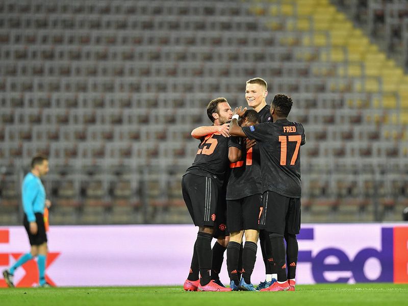 Manchester United's Welsh midfielder Daniel James celebrates with his teammates after scoring during the UEFA Europa League last 16, first leg football match Linzer ASK (LASK) v Manchester United in Linz, Austria, on March 12, 2020. The match is being held behind closed doors due to the new coronavirus COVID-19. / AFP / JOE KLAMAR