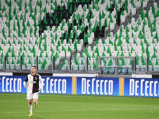 Juventus' Portuguese forward Cristiano Ronaldo runs on the pitch in an empty stadium due to the novel coronavirus outbreak