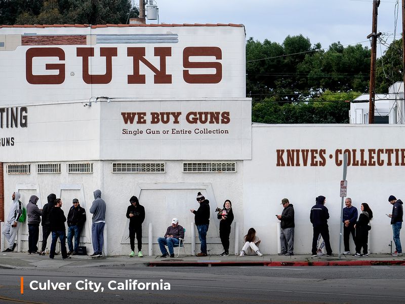 People wait in a line to enter a gun store in Culver City, California.