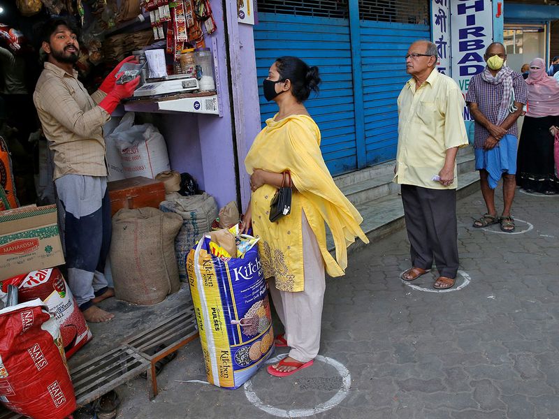 People queue standing in circles drawn to maintain safe distance as they wait to buy grocery items during a 21-day nationwide lockdown to limit the spreading of Coronavirus disease (COVID-19), in Kolkata.