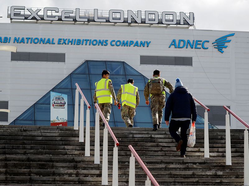Members of Britain's armed forces arrive at the ExCeL London exhibition centre in London.