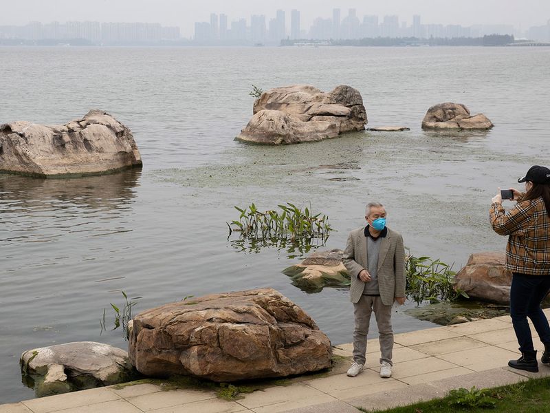 Visitors wearing mask against the coronavirus enjoy a quiet day at the East Lake park in Wuhan in central China's Hubei province.