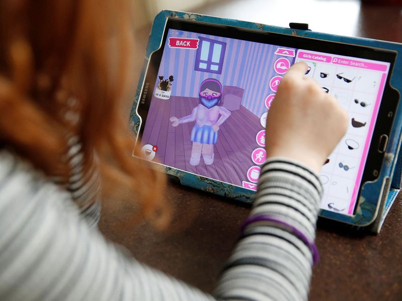  Alice Wilkinson (7) adds a face mask to her character on the game 'Roblox' at her home in Manchester, as the spread of COVID-19 continues, Manchester, Britain.