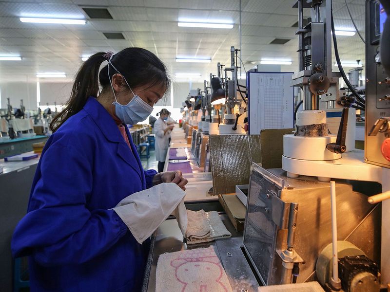 An employee working at a photoelectric production line at a factory in Wuhan in China's central Hubei province.