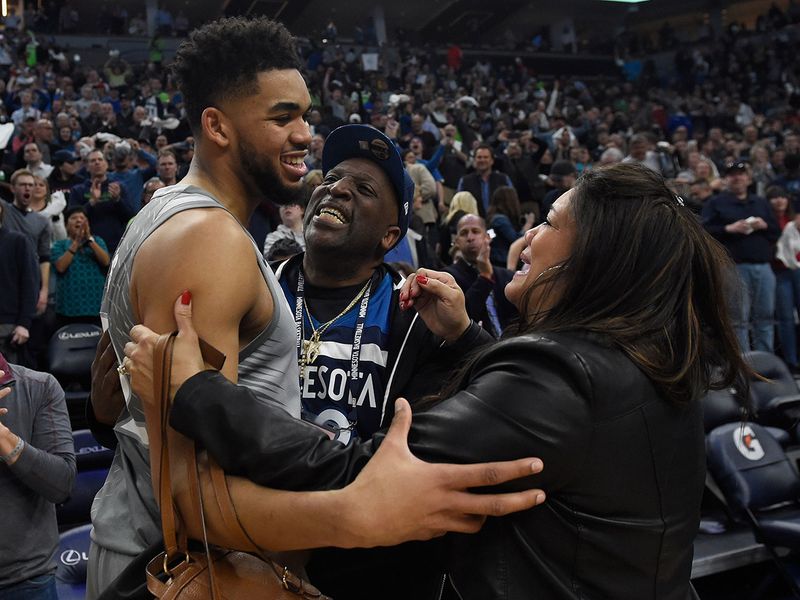 Karl-Anthony Towns of the Minnesota Timberwolves hugs his parents, Karl and Jackie Towns 