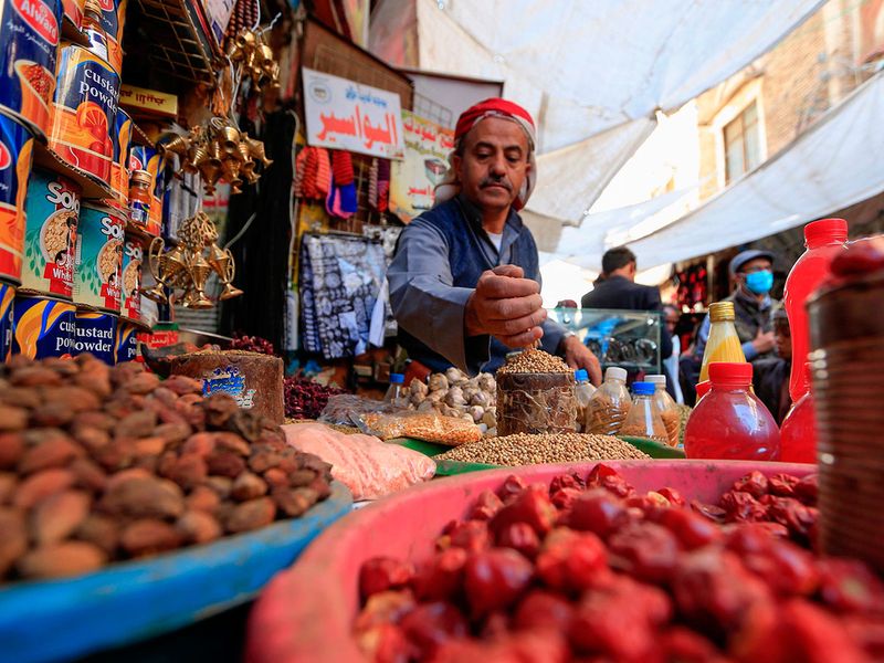 A Yemeni vendor waits for costumers in the old city market of the capital Sanaa ahead of the holy month of Ramadan.  Yemen recently reported its first case of the coronavirus in a southern province under the control of the government.