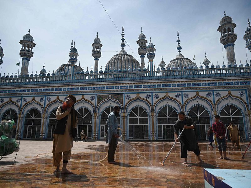 Muslim devotees wash the floor of the Jamia Mosque ahead of the Ramadan during a government-imposed nationwide lockdown as a preventive measure against the COVID-19 in Rawalpindi ahead of Ramadan.