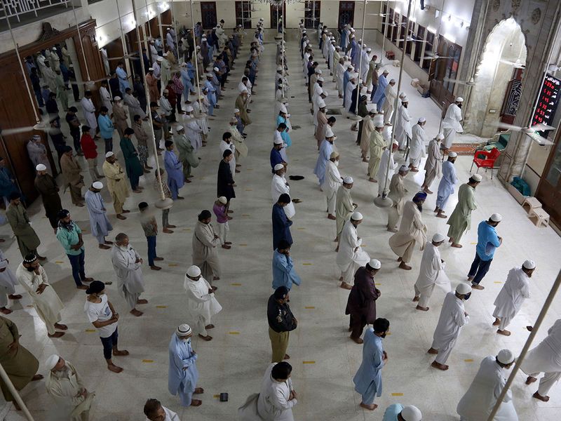 People attend evening prayers while maintaining a level of social distancing to help avoid the spread of coronavirus, at a mosque in Karachi, Pakistan. Prime Minister Imran Khan's government bowed to demands by religious leaders and agreed to keep mosques open during the month of Ramadan.