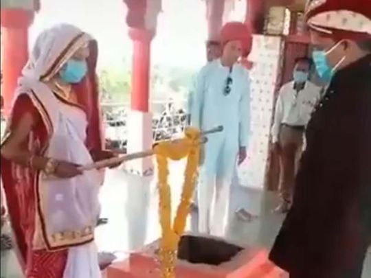 Indian couple exchange garlands