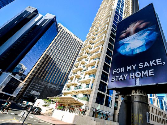A view of an advertisement board on display in a street in Dubai, advising residents to remain at home.  