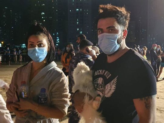 Residents seen wearing face masks after exiting towering inferno in Sharjah