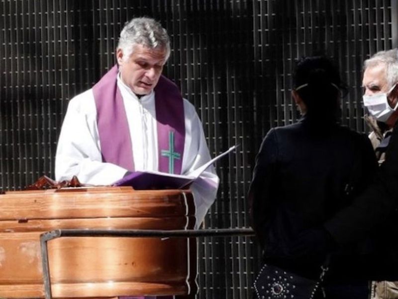 A priest conducts a funeral service in Pamplona, Spain, during the coronavirus pandemic.