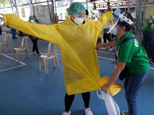 Health worker Philippines Manila protective suit