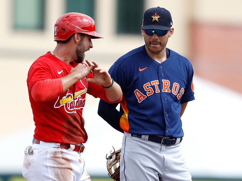     Paul DeJong, of the St. Louis Cardinals, left, chats with Houston Astros shortstop Carlos Correa during a spring practice baseball game ahead of the coronavirus lockdown.