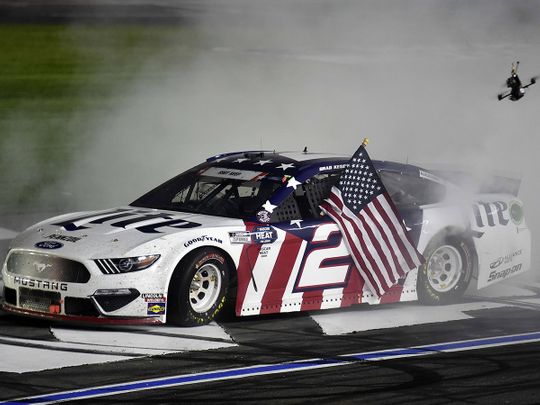 Brad Keselowski, driver of the #2 Miller Lite Ford, celebrates with a burnout after winning the NASCAR Cup Series Coca-Cola 600 at Charlotte Motor Speedway.