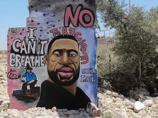 Artists paint a mural of George Floyd in war-torn Syria