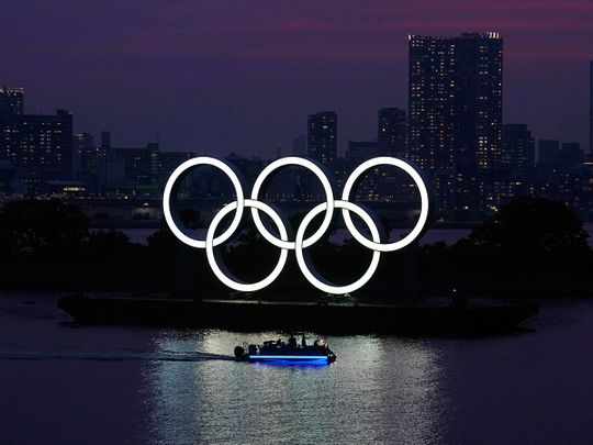 The Olympic rings float in the water at sunset in Odaiba. The Tokyo Olympics were postponed in March and are now scheduled to open on July 23, 2021. 
