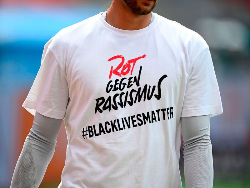 Bayern Munich's German goalkeeper Sven Ulreich wears a Tshirt with a message reading 'Red against racism 