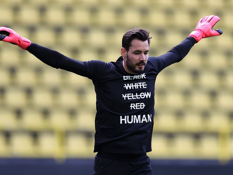 Dortmund's Swiss goalkeeper Roman Burki wears a T-shirt reading 