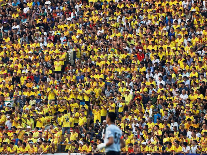 Fans pack the stands at a football match in Vietnam on Friday.