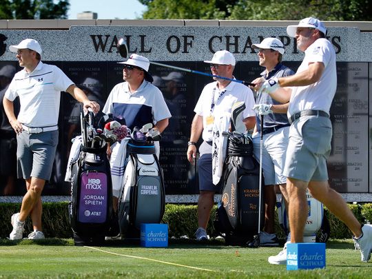 Jordan Spieth, left, watches Ryan Palmer tee off the first hole during practice for the Charles Schwab Challenge at Colonial in Fort Worth, Texas.