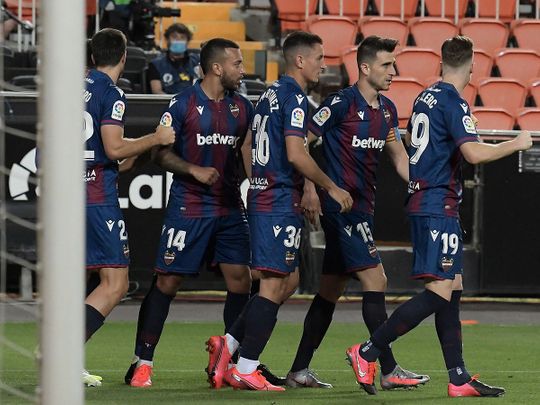 Levante players celebrate their equaliser against Valencia.